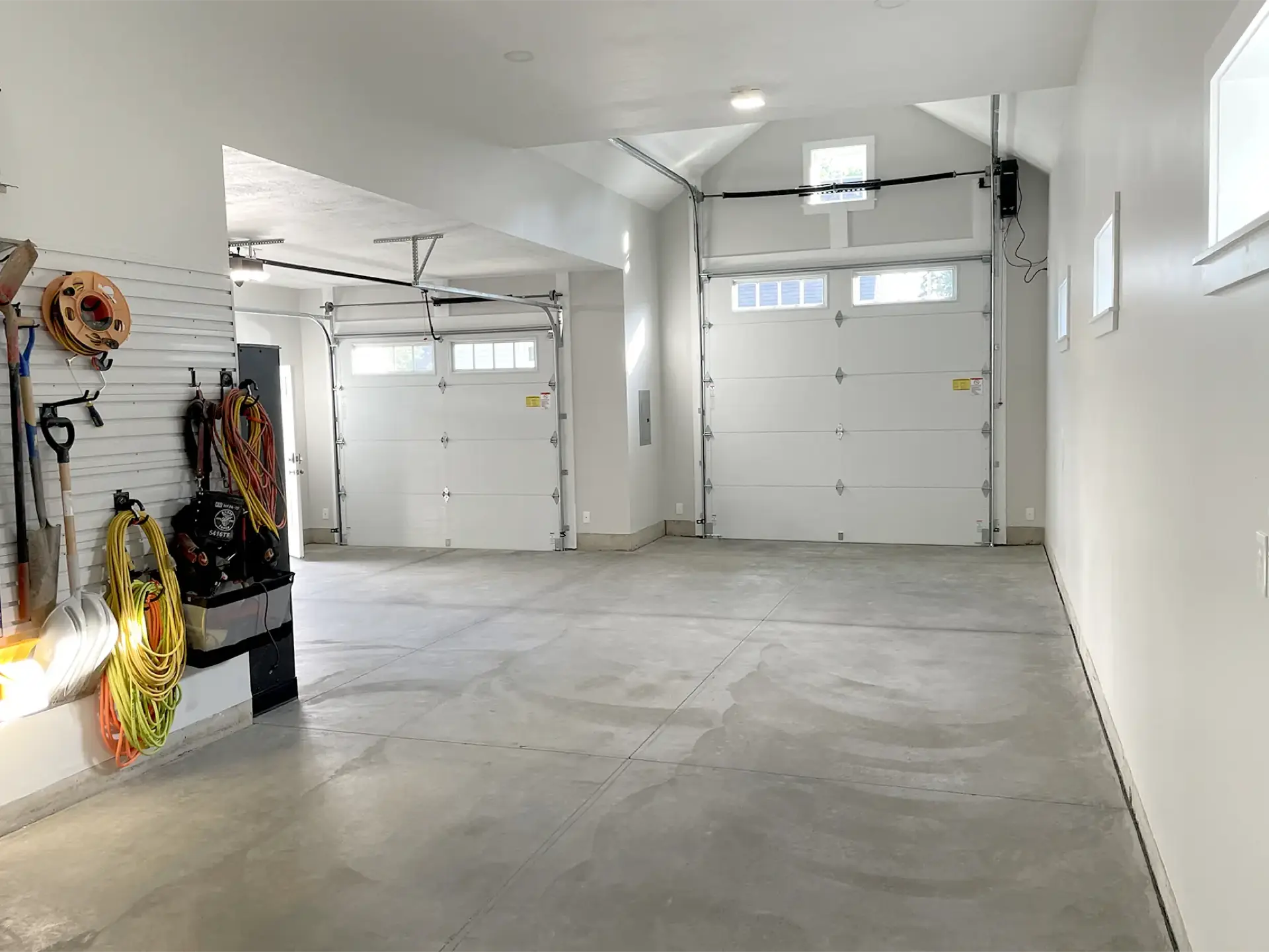 Two-bay garage interior with wall storage